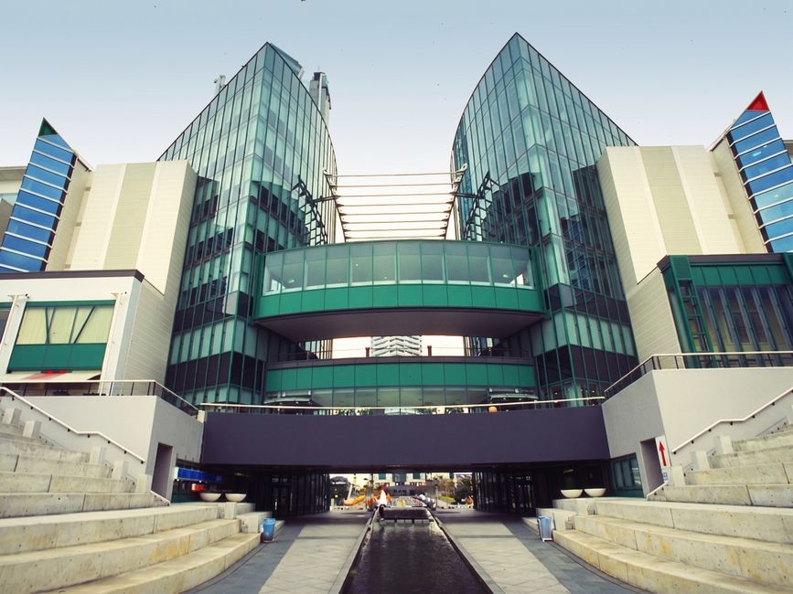Contemporary building featuring a glass facade and innovative design, perfect for business imagery.