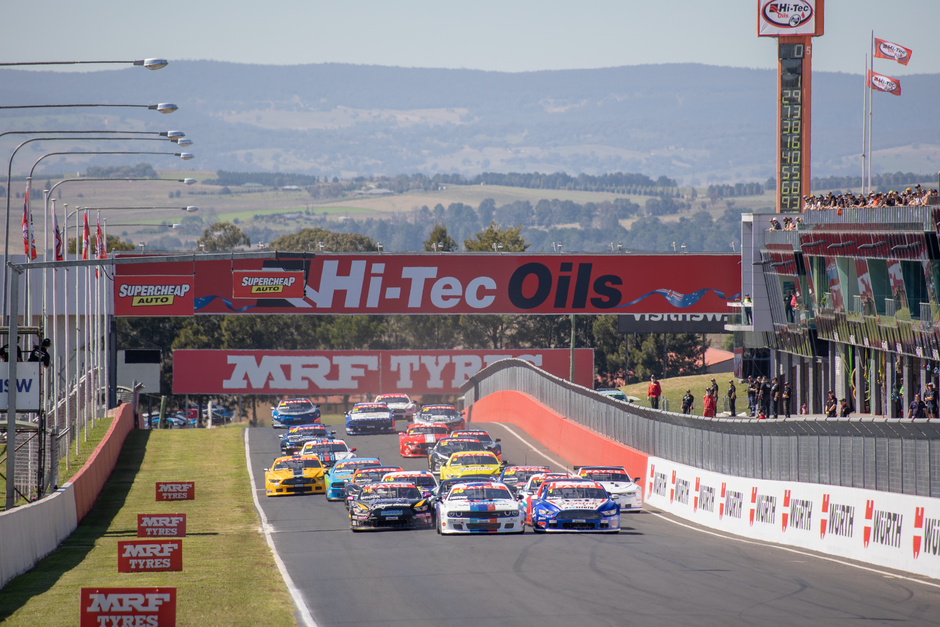 Exciting motorsport race featuring cars at Mount Panorama, Australia. Captivating speed and competition.