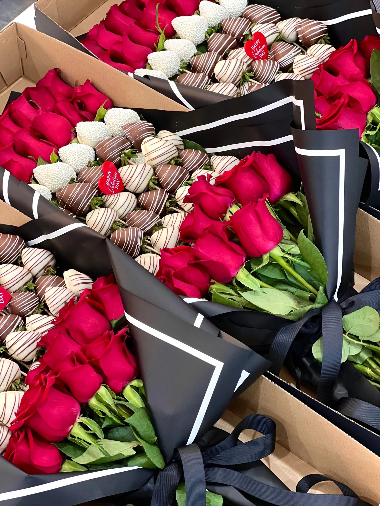 boxes filled with red roses and chocolate-covered strawberries from Flowers and Favours