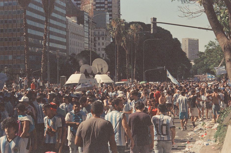 Lively street scene with football fans celebrating in Buenos Aires, Argentina.