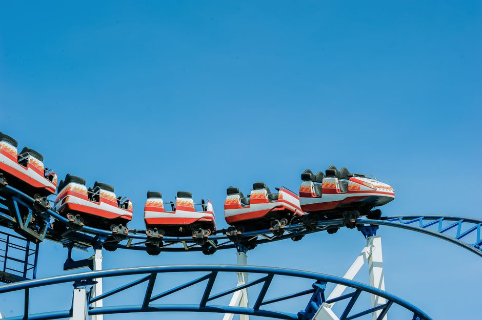 Exciting roller coaster ride with vibrant colors against a clear blue sky.