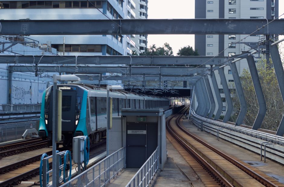 Sydney Metro train entering Chatswood Station in New South Wales, featuring urban architecture.